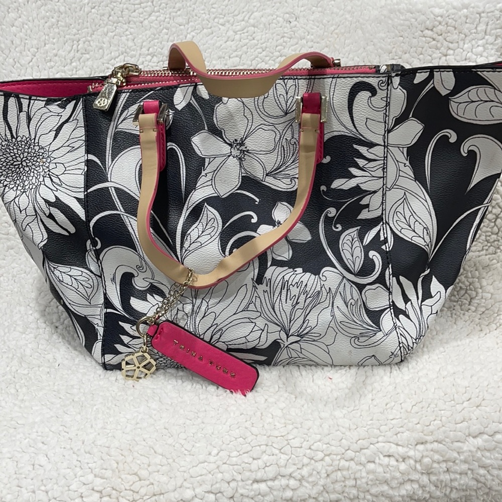 Trina Turk black and white purse with pink trim.